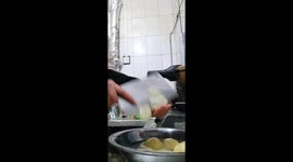 Woman skillfully slices potatoes by hand in China