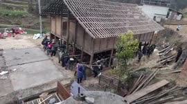 Heartwarming moment villagers carry home to new plot in China