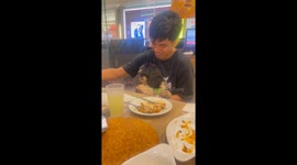 Pet Shih Tzu joins family at the table to eat Pizza Hut chicken meal