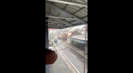 Worker running late gets hit by motorcycle... but carries on sprinting through rain
