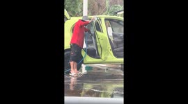 Bungling car wash worker sprays water inside vehicle
