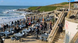 UK Weather, Spring promise as outdoor Sauna folk deluge in cold water. Fistral Beach, Cornwall, UK