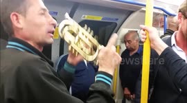 Musicians playing music on the London Underground