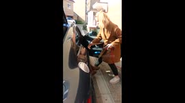 Mum manages to get stuck in the back seat of a car