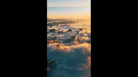 City engulfed in golden sea of clouds in China's Guizhou