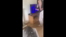 Mom screams after a scary face suddenly pops up on the TV screen