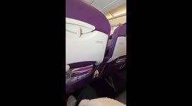 Shocked plane passenger records suspected thief rummaging through overhead compartment