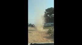 Dust devil tornado tears through roadside in Myanmar