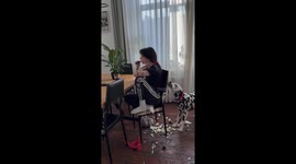 Woman Unbothered by Dog Biting Chair