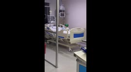 Child waves from hospital bed in Bogota