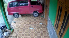 Woman slips while parking scooter in Ngawi, Indonesia