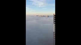 Bangalore skyline appears above the clouds
