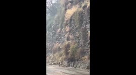 Driver hits the brakes as landslide crashes down mountainside