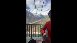 Brave tourist takes rickety zip line over 2,000ft high canyon in China