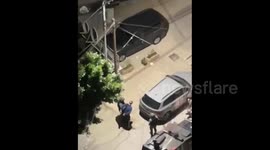 Israeli soldiers detain a Palestinian youth after raiding his home in Nablus
