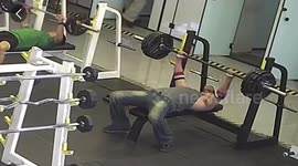 Painful moment gym-goer drops 200lb barbell on his chest during workout