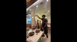 Couple try cheese stretching challenge at restaurant