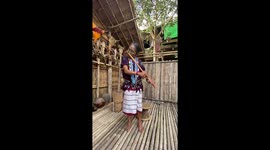 Elderly woman plays the flute with her nose