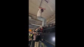 Roller blader jumps out of the bowl onto rail and the crowd saves him