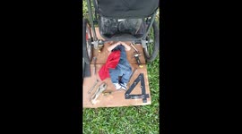 Baby dressed as a mechanic pretends to fix stroller in El Cerrito, Colombia
