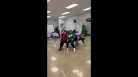 Woman slips during musical chairs at Christmas event in Los Angeles, California, USA