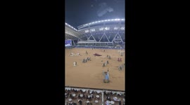 Horse gallops around aimlessly after rider falls off during show jumping event in Qatar