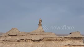 China: Wind-eroded Pillars Stand in The Desert in Hami