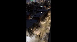 People Skiing on City Street After a Snowstorm
