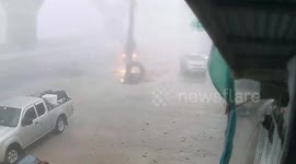 Summer storm batters shops, houses, and trees in northeast Thailand