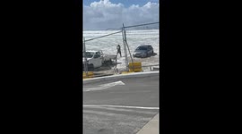 Aussie motorist rescues car being swept out to sea by strong waves whipped up by Cyclone Alfred