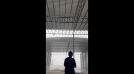 Howling storm tears roof from warehouse being built in Thailand