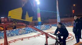 Man rides bicycle-powered cart on roller coaster track in Liaoning, China