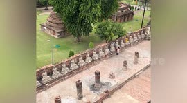 Indian tourists spark outrage by climbing across historic temple to steal mangoes