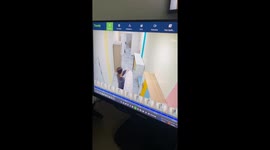 Man bumps head while carrying a carpet in Astana, Kazakhstan