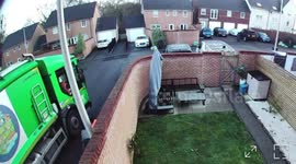 Garbage collector throws bin into truck after mishap in Cardiff, Wales, UK