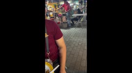 Pet dog begs for food from locals eating their dinner