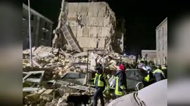 Firemen search for residents trapped under collapsed building in Italy