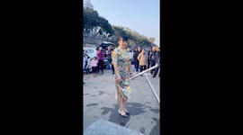 Elegant woman in qipao tries water bicycle in China