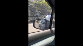 Furious motorcyclist kicks car's wing mirror 'after being cut off'