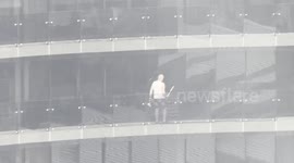 Man Seen Cleaning Windows Amid Cyclone Alfred's Wild Weather on Gold Coast
