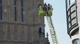 London, UK. 8 March 2025. Pro Palestine man climb on the Big Ben tower by Parliament.