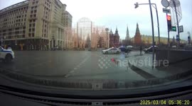 Man wearing pompom hat runs onto road to stop motorcade in Moscow, Russia