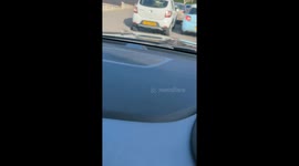 Road rage as two cars jostle to be first in the queue in traffic!