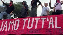 Entertainment workers with purple smoke bombs display a banner with the slogan 'we want something different' during the march organized by the feminist and transfeminist movement ‘Non Una di Meno’ (Not One Less) on the occasion of International Women's Da