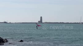 People practice wing foil in the stretch of sea near the old lighthouse where the construction of the cruise tourist port is planned in Fiumicino near Rome .