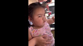 Toddler looks seriously annoyed with bumpy tricycle ride