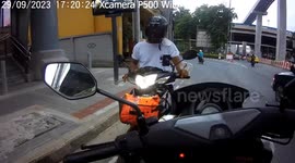 Thai policeman chases motorcycle rider who refuses to stop for inspection