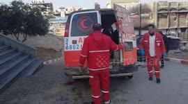 Palestine Red Crescent crews are transporting a person with a gunshot wound to the shoulder