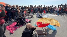 People demonstrate in the area in front of the old lighthouse following the construction of a fence that limits access to the beach in front of the historic fishing platforms, in Fiumicino near Rome.