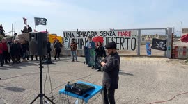 People demonstrate in the area in front of the old lighthouse following the construction of a fence that limits access to the beach in front of the historic fishing platforms, in Fiumicino near Rome.